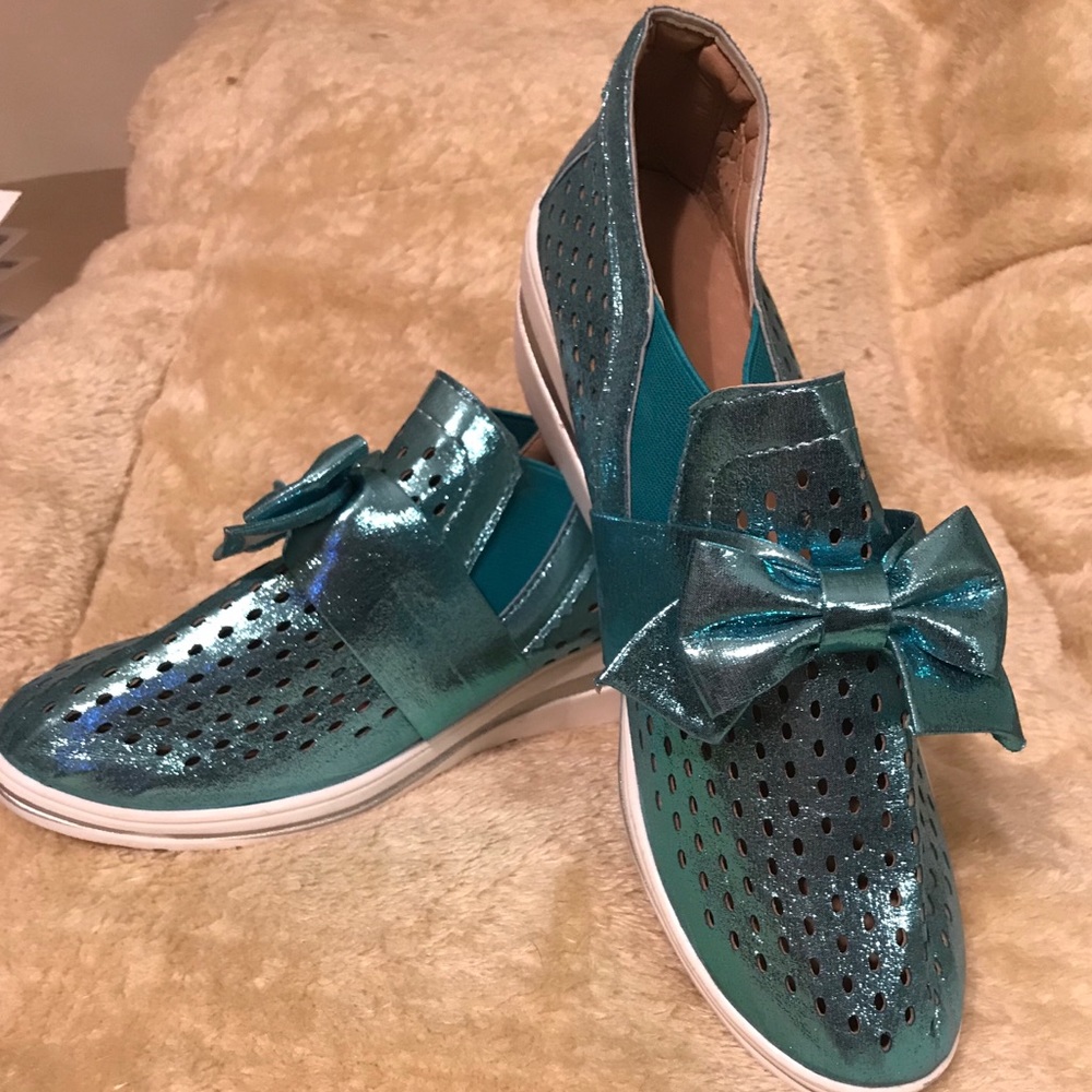 Blue metallic bowed sneakers.